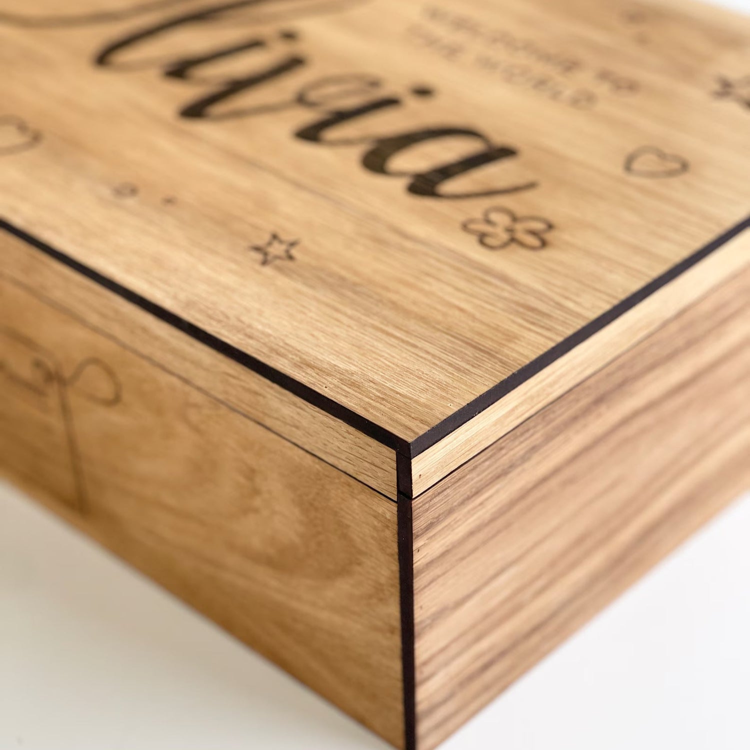 Wooden box with engraved name 'Olivia' on a white background