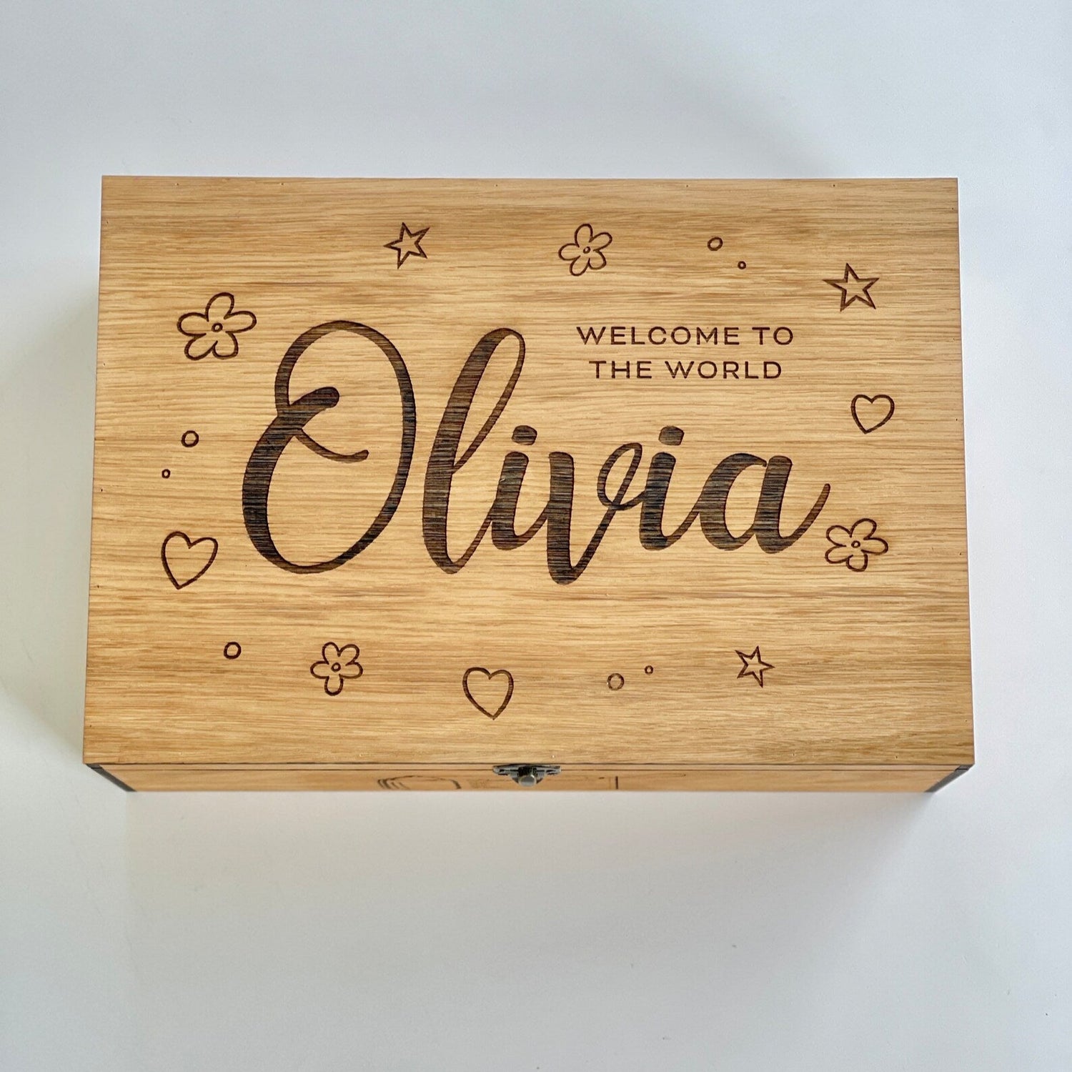 Wooden box with engraved text 'Welcome to the World Olivia' on a white background