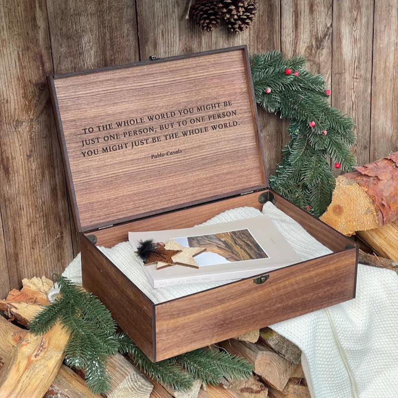 Wooden box with engraved text on a wooden background with Christmas decorations