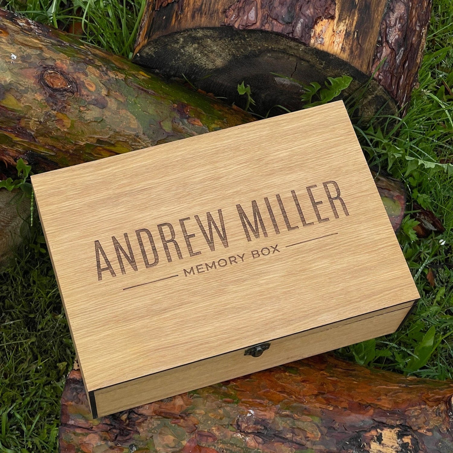 Wooden memory box with 'Andrew Miller' engraving on a natural background