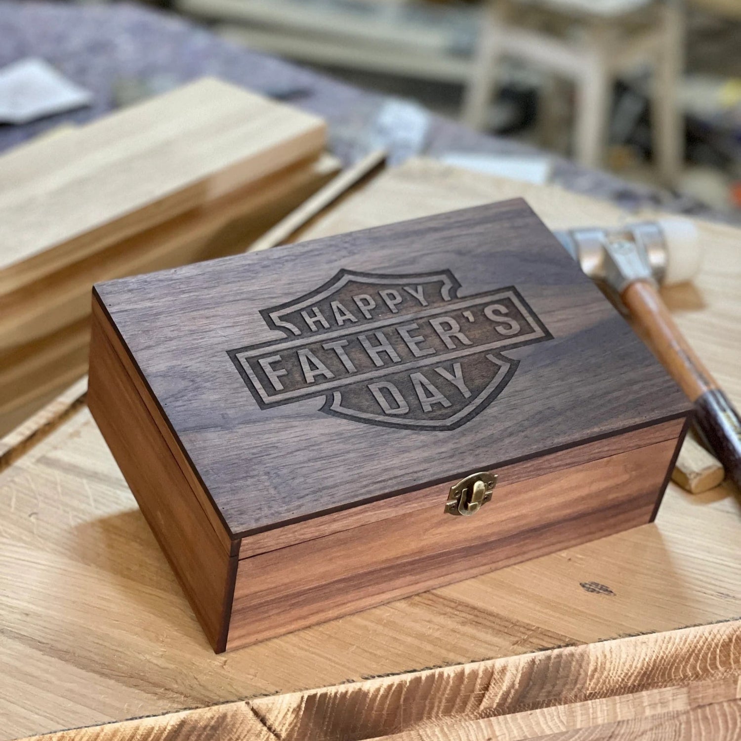 Wooden box with 'Happy Father's Day' engraving on a wooden surface.