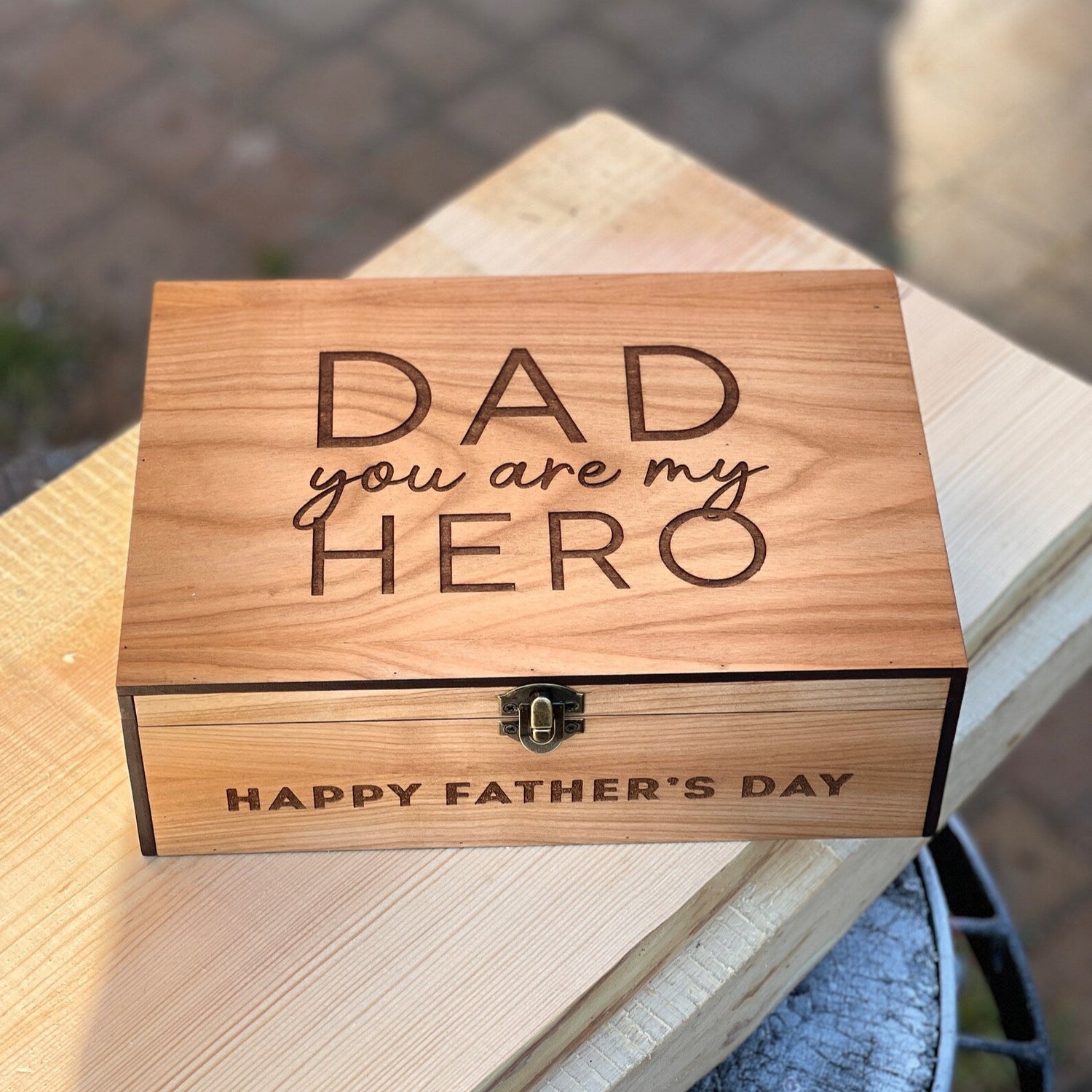 Wooden box with engraved message on a wooden surface