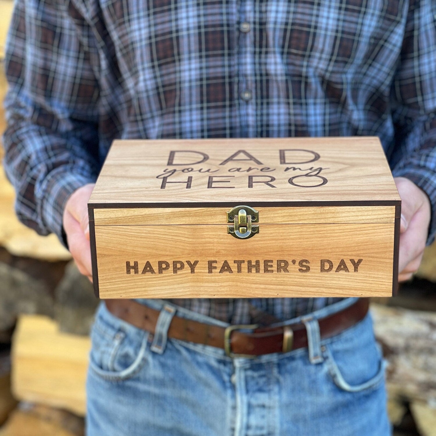 Person holding a wooden box with 'Dad, You're My Hero' and 'Happy Father's Day' text.