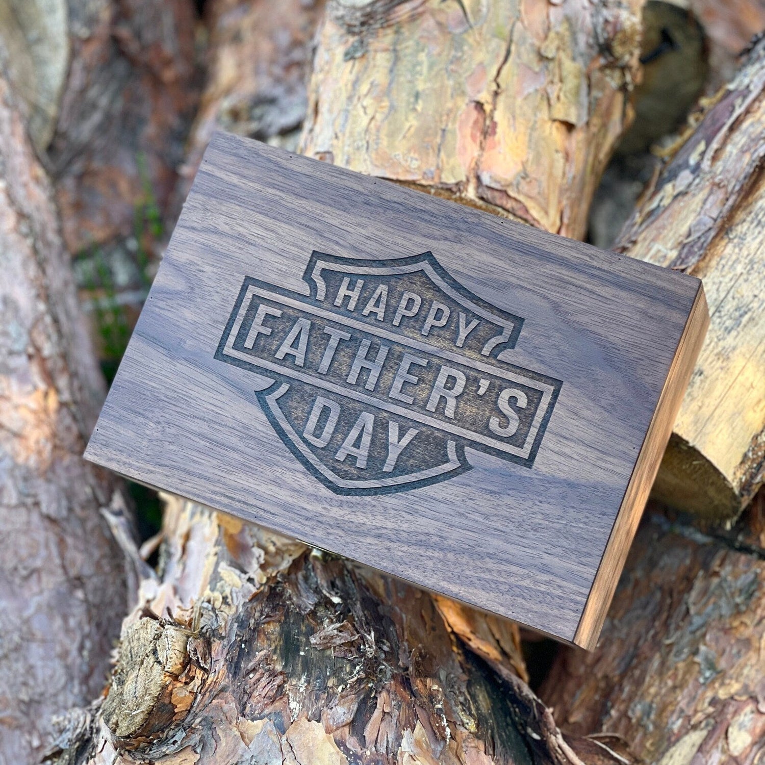 Wooden card with 'Happy Father's Day' on a tree trunk background