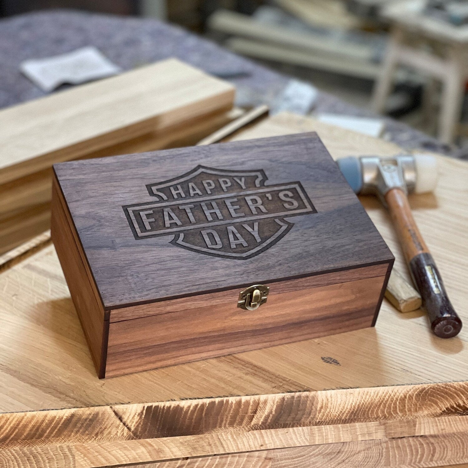 Wooden box with 'Happy Father's Day' engraving on a wooden surface.