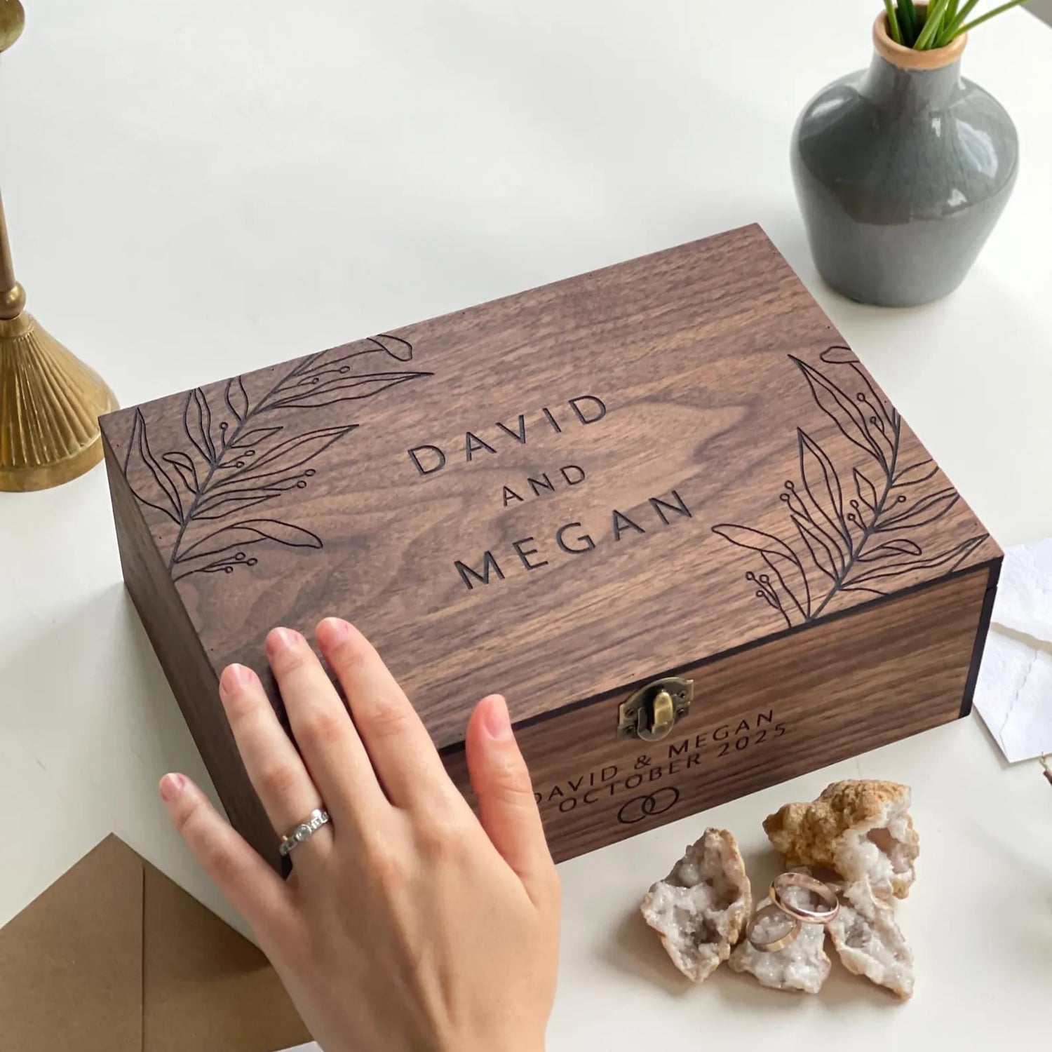 Wooden box engraved with 'David and Megan' on a white surface.