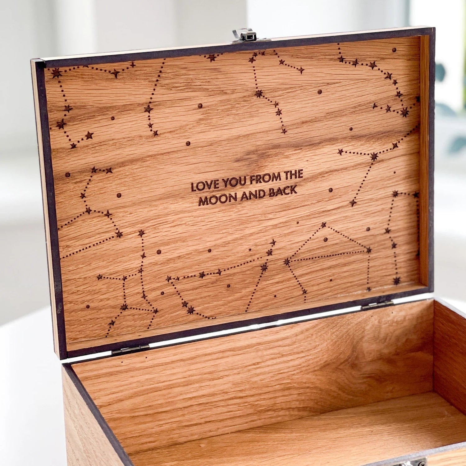 Wooden box with star constellation design and 'Love you from the moon and back' text.
