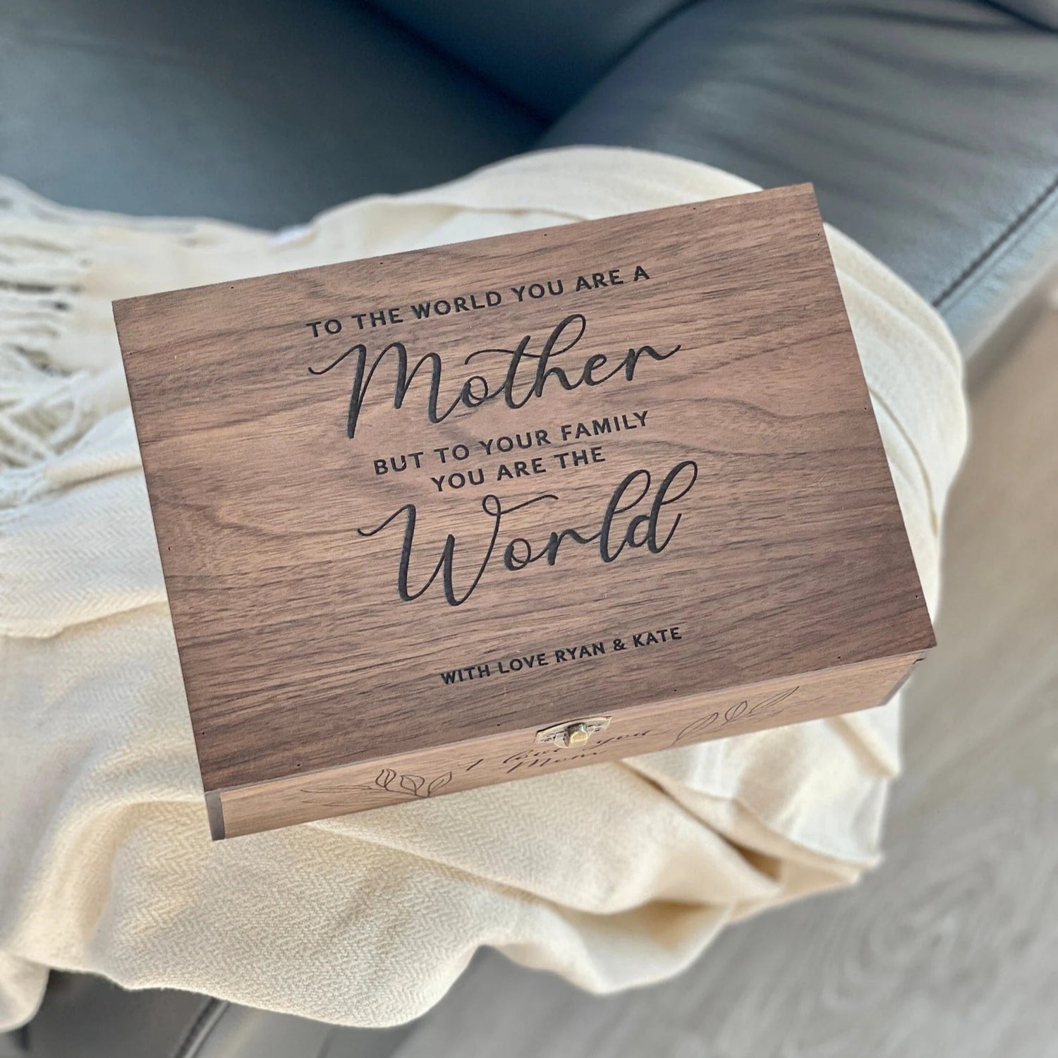 Wooden box with engraved message on a light-colored fabric background