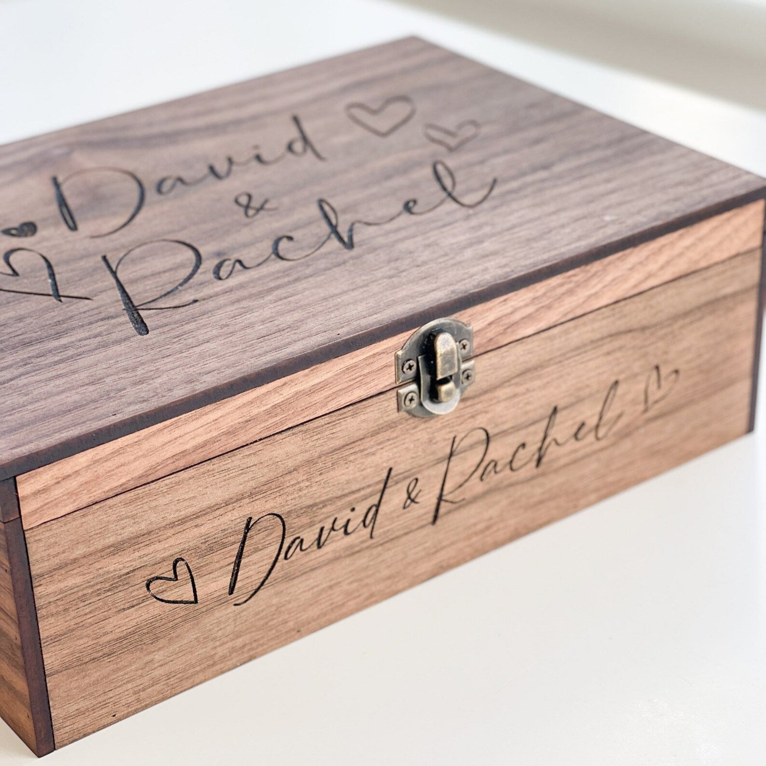 Wooden box with 'David & Rachel' engraving on a white background