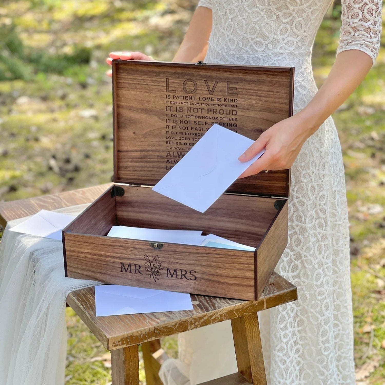 Wooden box with 'Mr & Mrs' engraving on a stool outdoors