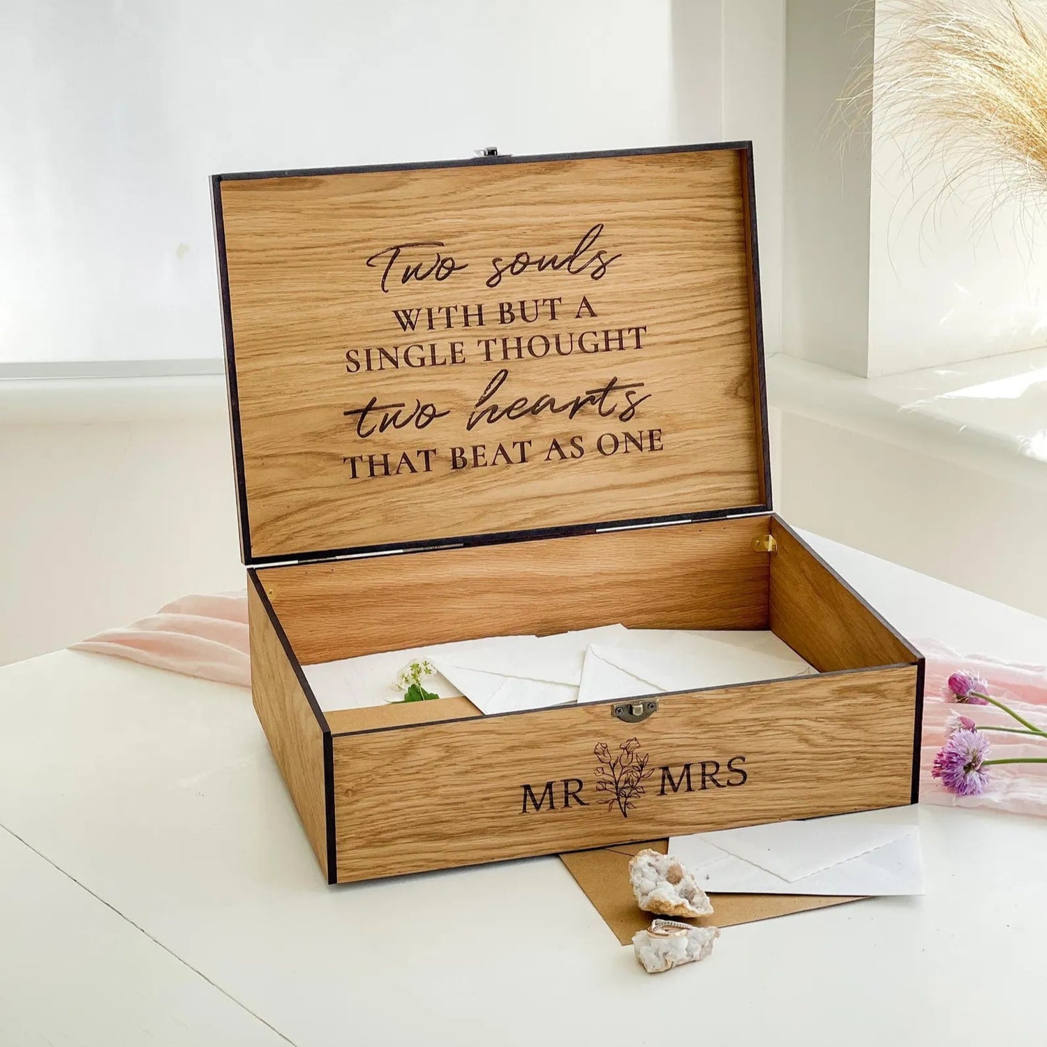 Wooden box with engraved text and 'MR & MRS' on a white surface