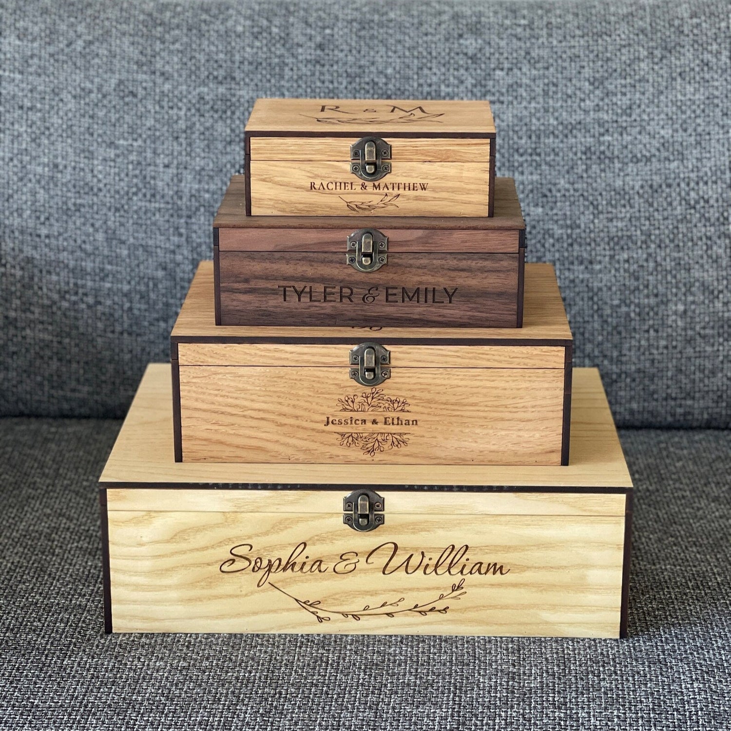 Stack of personalized wooden boxes on a textured surface
