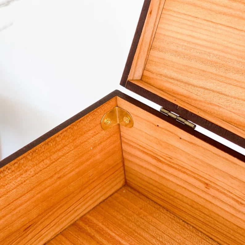 Wooden jewelry box with a gold clasp on a white background